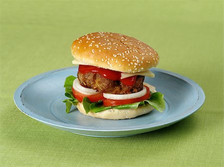 simsearch:400-06090558,k - Photo of a hamburger on a blue plate resting on a green table cloth. Stock Photo - Budget Royalty-Free & Subscription, Code: 400-06743342