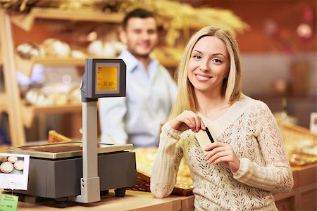 Beautiful girl with a credit card in a store Stock Photo - Budget Royalty-Free & Subscription, Code: 400-06759040