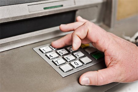 simsearch:400-05670021,k - a man uses an ATM to enter his pin Stock Photo - Budget Royalty-Free & Subscription, Code: 400-06759190