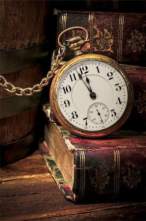 pocket watch - Antique pocket clock showing a few minutes to midnight over ancient books in Low-key. Concept of time,the past or deadline. Stock Photo - Budget Royalty-Free & Subscription, Code: 400-06759876