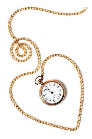 Heart path made with a gold chain and a pocket watch inside showing a few minutes to midnight, isolated on white background. Concept of permanence of love over time,the past or deadline. Photographie de stock - Aubaine LD & Abonnement, Code: 400-06759879