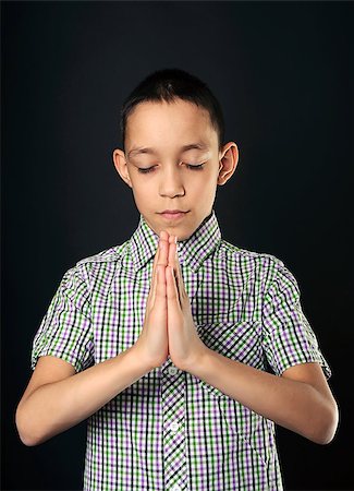 portrait of praying boy wearing shirt with closed eyes over black Stock Photo - Budget Royalty-Free & Subscription, Code: 400-06751373