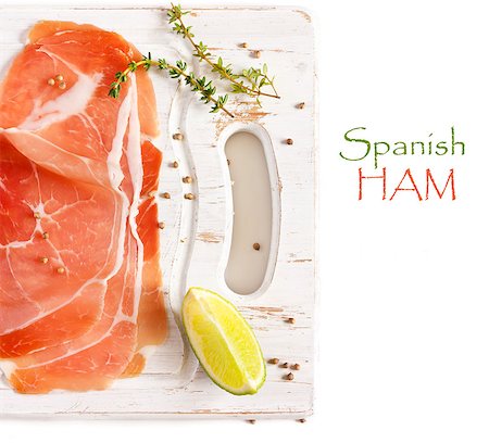 simsearch:400-06207145,k - Sliced Spanish ham on an old white cutting board. Stock Photo - Budget Royalty-Free & Subscription, Code: 400-06767694