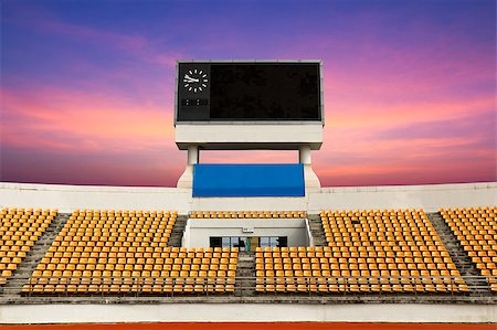 soccer arena - Rows of orange seats on the stadium with scoreboard displaying clock above them Stock Photo - Budget Royalty-Free & Subscription, Code: 400-06760839