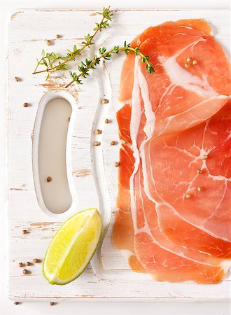 simsearch:400-06207145,k - Sliced ham with thyme and lime on an old white kitchen board. Stock Photo - Budget Royalty-Free & Subscription, Code: 400-06763914