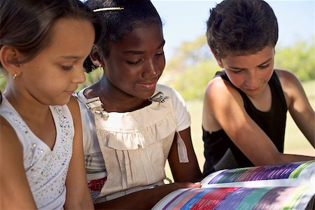 students reading in groups - Young people and education, two little girls and one boy reading book in city park Stock Photo - Budget Royalty-Free & Subscription, Code: 400-06770221