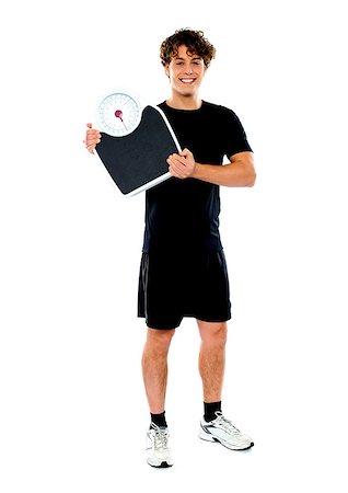 simsearch:400-06482604,k - Handsome fit man holding weight machine over white background background Stock Photo - Budget Royalty-Free & Subscription, Code: 400-06770836