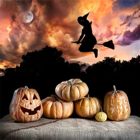 Halloween pumpkins on the table and witch silhouette flying at dramatic night sky with moon Stock Photo - Budget Royalty-Free & Subscription, Code: 400-06772677