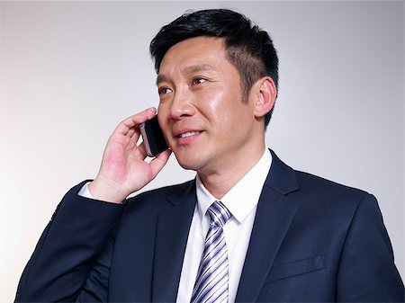 simsearch:859-06710917,k - asian businessman talking on phone. Stock Photo - Budget Royalty-Free & Subscription, Code: 400-06787379