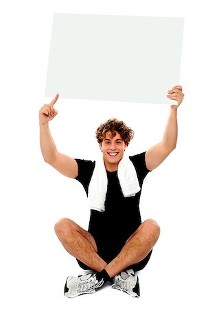 simsearch:400-06482604,k - Athlete pointing towards blank banner ad over his head Stock Photo - Budget Royalty-Free & Subscription, Code: 400-06795505