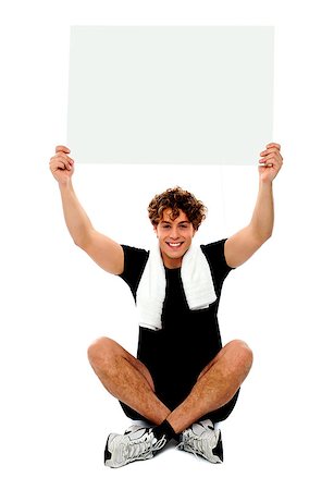 simsearch:400-06482604,k - Handsome athlete holding blank placard over his head. Towel wrapped around neck Stock Photo - Budget Royalty-Free & Subscription, Code: 400-06795506