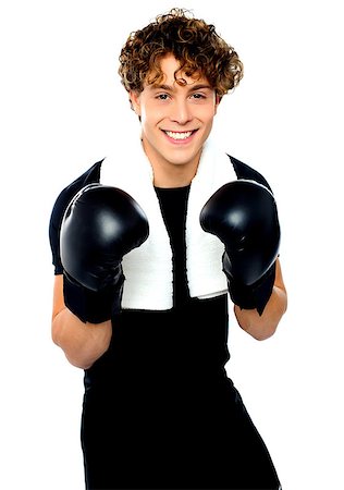 Boxer boy in sports outfit ready to punch you. Towel around his neck Stock Photo - Budget Royalty-Free & Subscription, Code: 400-06795500