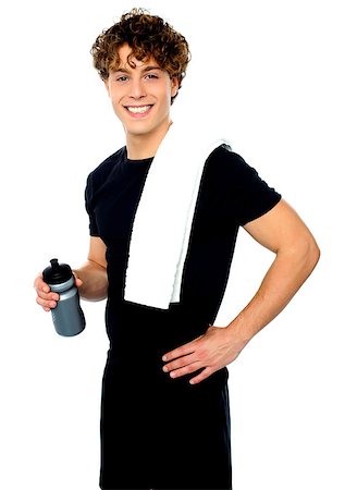 simsearch:400-06482604,k - Smiling young man holding towel on shoulders and sport bottle isolated over an isolated background Stock Photo - Budget Royalty-Free & Subscription, Code: 400-06795502