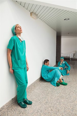 distressed female physician - Three surgeons taking break in hospital corridor Stock Photo - Budget Royalty-Free & Subscription, Code: 400-06799545