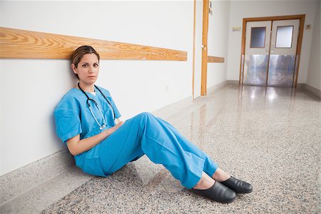 Nurse is sitting on the floor looking at the camera Stock Photo - Budget Royalty-Free & Subscription, Code: 400-06799712