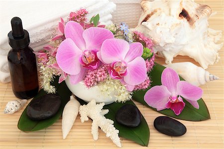 essential - Aromatherapy treatment with spa stones, essential oil, flowers, shells and towels over bamboo background. Stock Photo - Budget Royalty-Free & Subscription, Code: 400-06791575