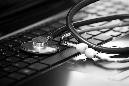 Silver stethoscope lying down on an laptop Stock Photo - Budget Royalty-Free & Subscription, Code: 400-06791570