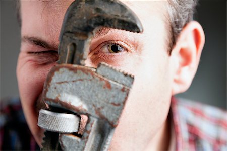 pipe wrench - Closeup image of a man's face with the pipe wrench in front Stock Photo - Budget Royalty-Free & Subscription, Code: 400-06793149
