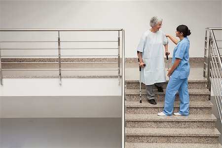 Nurse helping elderly lady on crutches get down hospital stairs Stock Photo - Budget Royalty-Free & Subscription, Code: 400-06800598