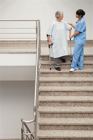 down stairs pictures - Elderly patient on crutches being helped by nurse to go down stairs Stock Photo - Budget Royalty-Free & Subscription, Code: 400-06800599