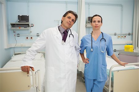 Doctor and nurse smiling in hospital bedroom Stock Photo - Budget Royalty-Free & Subscription, Code: 400-06800593