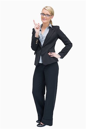 executive standing white background - Smiling businesswoman thinking and pointing up Photographie de stock - Aubaine LD & Abonnement, Code: 400-06802276