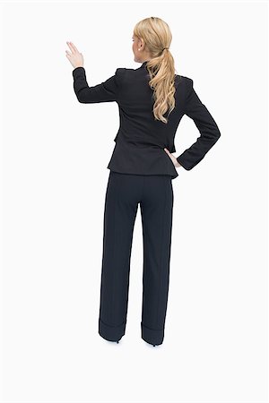 executive standing white background - Businesswoman standing and pointing out something while being reversed Photographie de stock - Aubaine LD & Abonnement, Code: 400-06802300