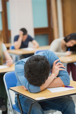Boy sleeping at desk during exam in exam hall in college Stock Photo - Budget Royalty-Free & Subscription, Code: 400-06803034