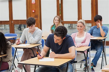 Students sitting at the exam room while writing Stock Photo - Budget Royalty-Free & Subscription, Code: 400-06803121