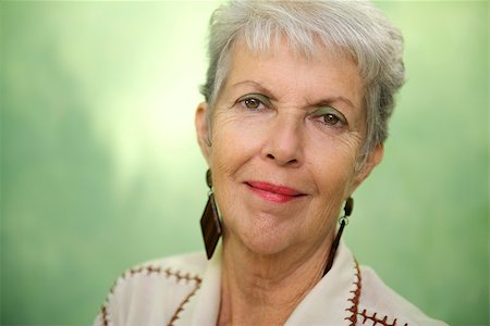 simsearch:400-06142278,k - Senior women, portrait of old caucasian lady looking and smiling at camera against green background Stock Photo - Budget Royalty-Free & Subscription, Code: 400-06854116