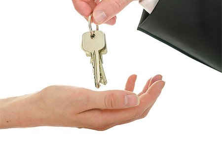 simsearch:400-04663994,k - Man handing house keys over to a new owner. Isolated over white background. Stock Photo - Budget Royalty-Free & Subscription, Code: 400-06855781