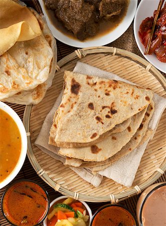 simsearch:400-07418409,k - Indian bread, Chapati flatbread, roti canai, dal, curry, teh tarik or pulled tea, acar. Famous indian food. Stock Photo - Budget Royalty-Free & Subscription, Code: 400-06858499