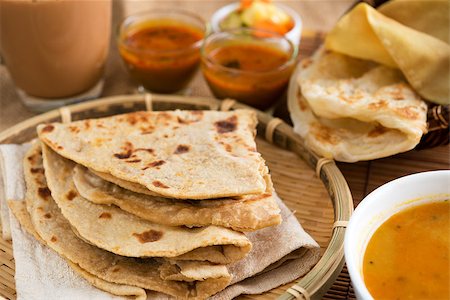 simsearch:400-07418409,k - Indian food, Chapati flatbread, roti canai, dal, curry, teh tarik or pulled tea, acar. Famous indian cuisine. Stock Photo - Budget Royalty-Free & Subscription, Code: 400-06858500