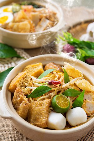 simsearch:400-07418409,k - Hot and spicy Malaysian Curry Noodles or laksa  mee with hot steam in clay pot, decoration setup, serve with chopsticks. Malaysia cuisine. Stock Photo - Budget Royalty-Free & Subscription, Code: 400-06858919