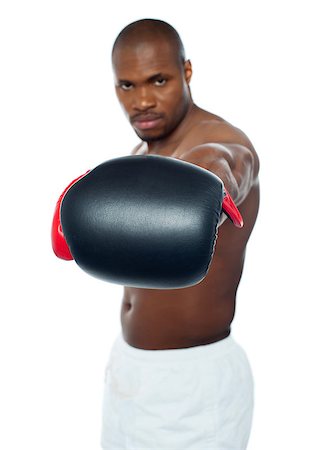 simsearch:400-06482604,k - Muscular black boxer punching right into camera. Feel the heat. Stock Photo - Budget Royalty-Free & Subscription, Code: 400-06859195