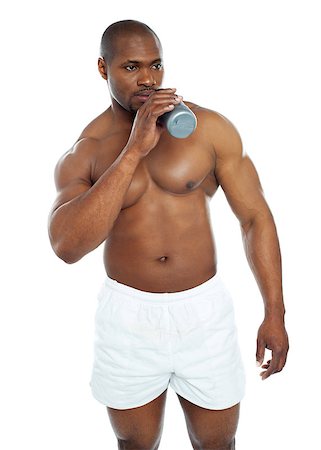 simsearch:400-06859193,k - Muscular male drinking health drink and looking away Stock Photo - Budget Royalty-Free & Subscription, Code: 400-06859192