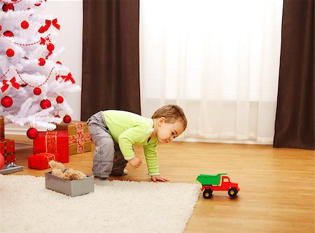 Little boy in Christmas; playing with the new toy car Stock Photo - Budget Royalty-Free & Subscription, Code: 400-06859654