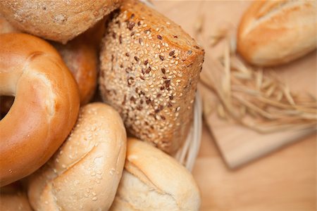 Diffferent bread in the basket with a roll on a wooden board Stock Photo - Budget Royalty-Free & Subscription, Code: 400-06864818
