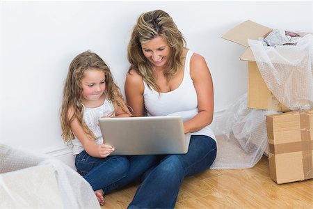 Smiling mother and daughter using laptop Stock Photo - Budget Royalty-Free & Subscription, Code: 400-06865752