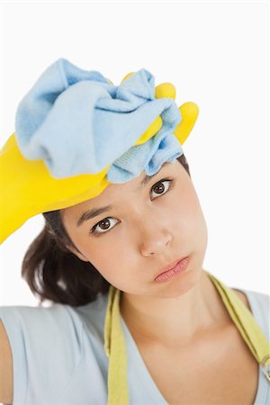 simsearch:400-06863660,k - Woman wiping the sweat off her head wearing rubber gloves and holding rag Stock Photo - Budget Royalty-Free & Subscription, Code: 400-06866423