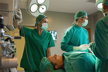 Surgeons working on a female patient in an operating theater Stock Photo - Budget Royalty-Free & Subscription, Code: 400-06868027