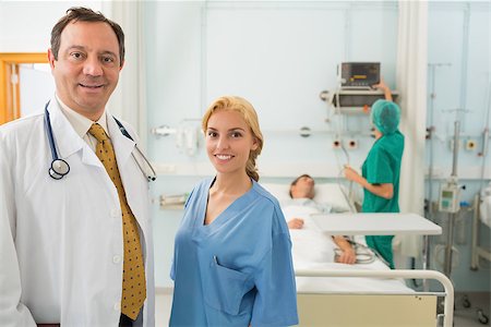 Doctor and nurse talking in a hospital room where patients are resting Stock Photo - Budget Royalty-Free & Subscription, Code: 400-06868033