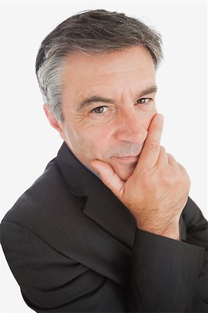simsearch:400-04283915,k - Closeup portrait of thoughtful businessman with hand on chin over white background Stock Photo - Budget Royalty-Free & Subscription, Code: 400-06868644