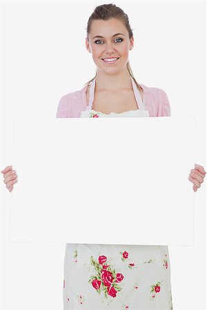 Portrait of young maid holding blank billboard over white background Stock Photo - Budget Royalty-Free & Subscription, Code: 400-06868751
