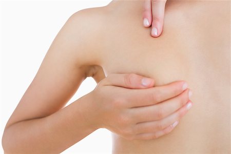 simsearch:400-07835111,k - Closeup of naked woman examining breast over white background Stock Photo - Budget Royalty-Free & Subscription, Code: 400-06869934