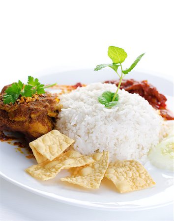 simsearch:400-07418409,k - Nasi lemak traditional malaysian hot and spicy rice dish. Served with belacan, ikan bilis, acar, peanuts and cucumber. White background. Famous malaysian food. Stock Photo - Budget Royalty-Free & Subscription, Code: 400-06860617