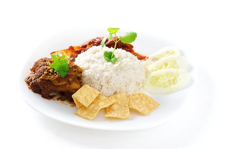 simsearch:400-07418409,k - Nasi lemak traditional malaysian spicy rice dish. Served with belacan, ikan bilis, acar, peanuts and cucumber. Malaysian food. Asian cuisine. Stock Photo - Budget Royalty-Free & Subscription, Code: 400-06860619