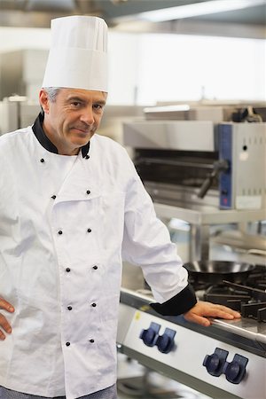 Chef leaning against the stove in kitchen Stock Photo - Budget Royalty-Free & Subscription, Code: 400-06863271