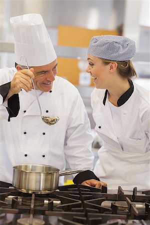 Smiling student and teacher discussing the soup in the kitchen Stock Photo - Budget Royalty-Free & Subscription, Code: 400-06863281