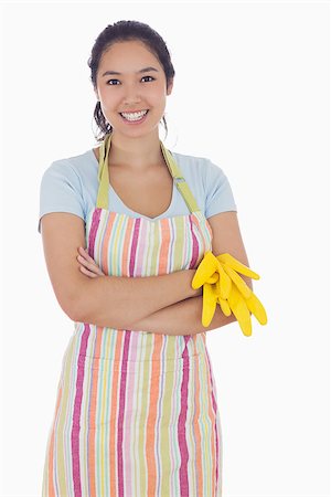 simsearch:400-06863660,k - Woman smiling while holding rubber gloves and wearing an apron Stock Photo - Budget Royalty-Free & Subscription, Code: 400-06863559